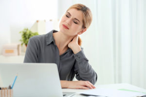 Woman at desk with neck pain